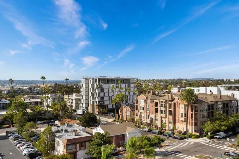 a living room with furniture a flat screen tv and a large window