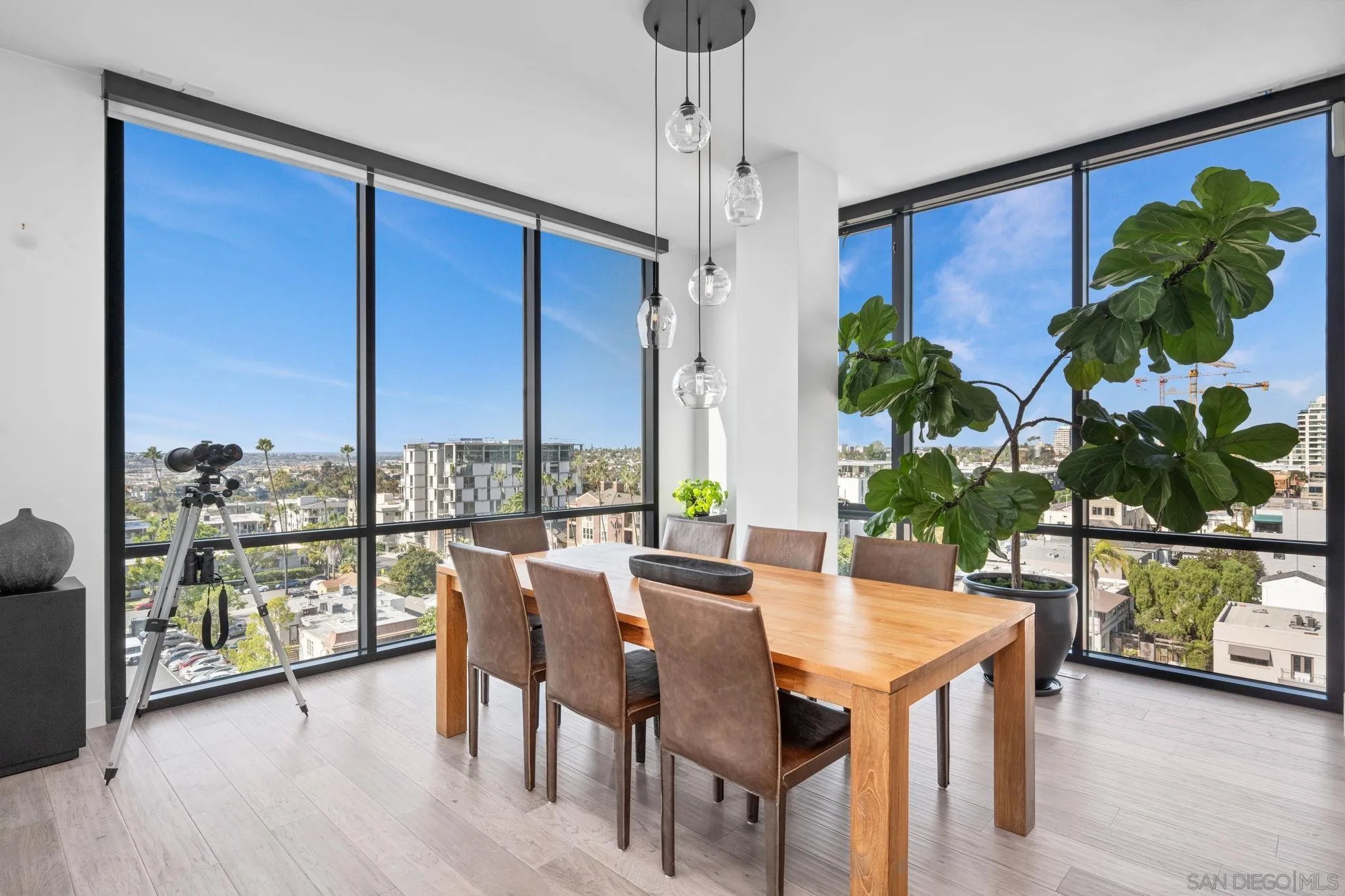 2604 Fifth Avenue, Unit 804 San Diego, CA 92103 - Photo 6 of 72 a dining room with furniture a chandelier and wooden floor