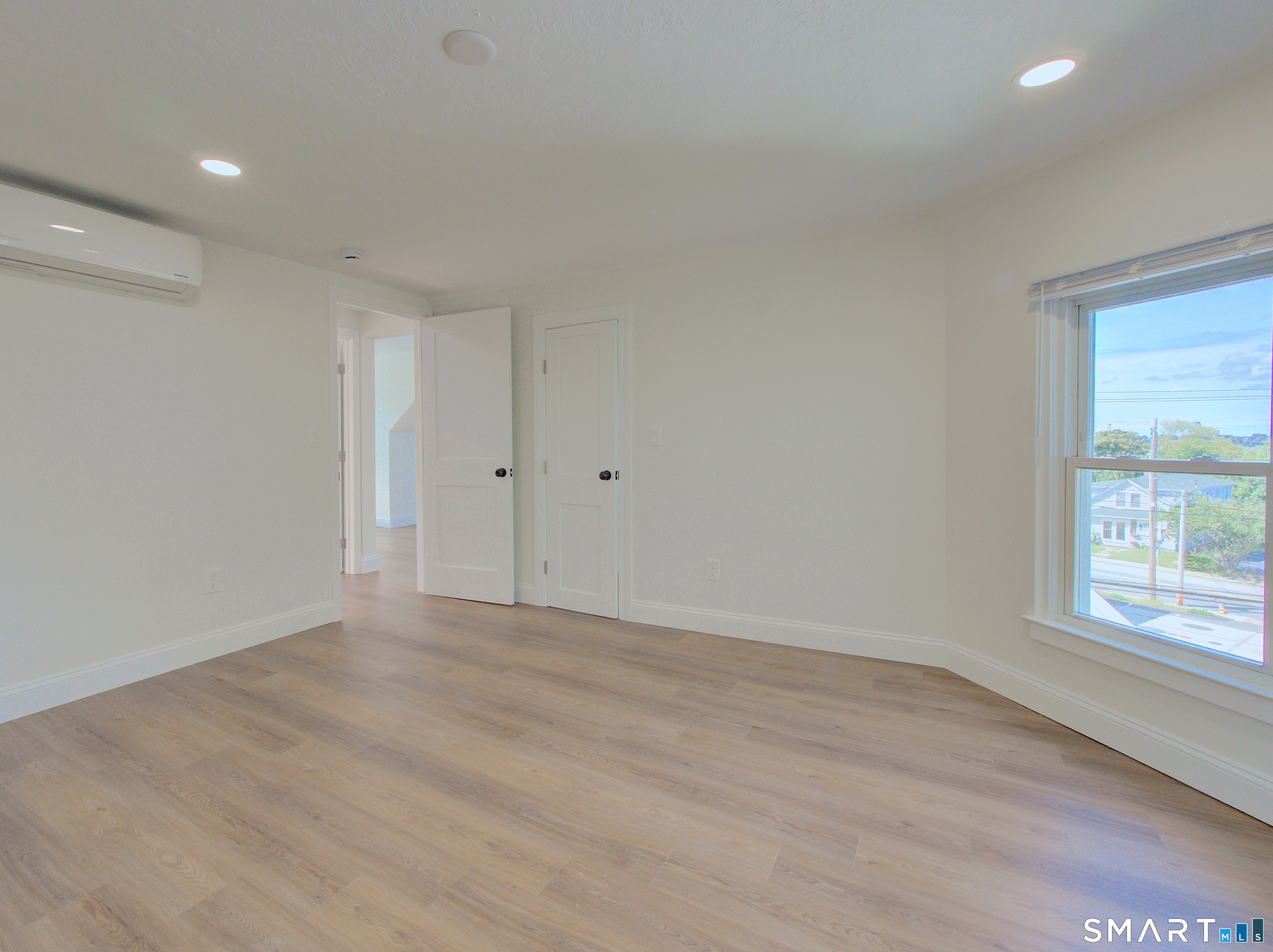 16 Benham Road, Unit D Groton, CT 06340 - Photo 11 of 15 wooden floor in an empty room with a window