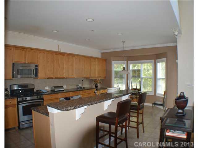 1705 Copperplate Road Charlotte, NC 28262 - Photo 2 of 14 a kitchen with stainless steel appliances granite countertop a stove a sink a microwave and a refrigerator