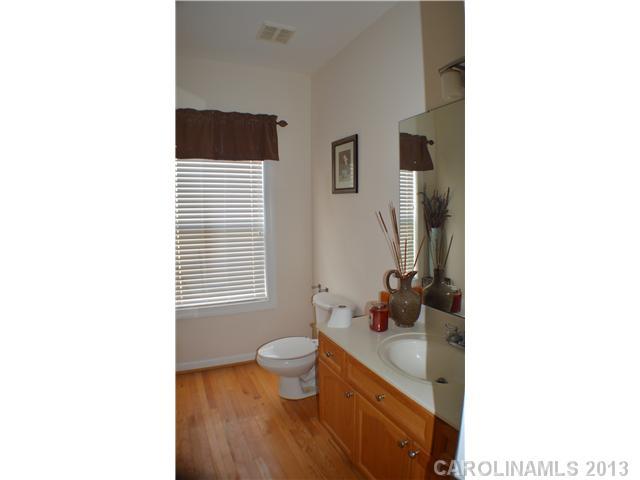 1705 Copperplate Road Charlotte, NC 28262 - Photo 8 of 14 a bathroom with a toilet sink and mirror