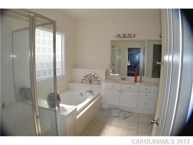 1705 Copperplate Road Charlotte, NC 28262 - Photo 9 of 14 a bathroom with a tub sink and mirror