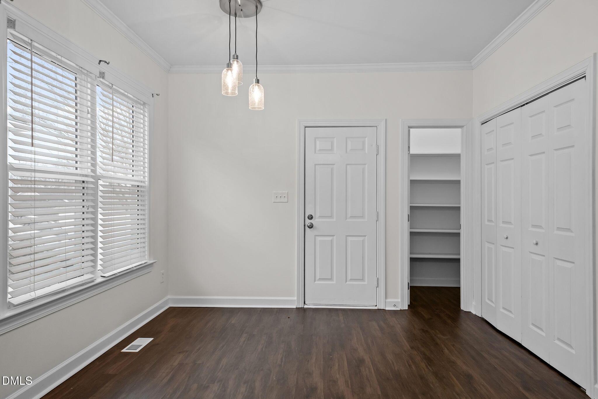 1953 Castle Pines Drive Raleigh, NC 27604 - Photo 11 of 47 a view of an empty room with a window and wooden floor