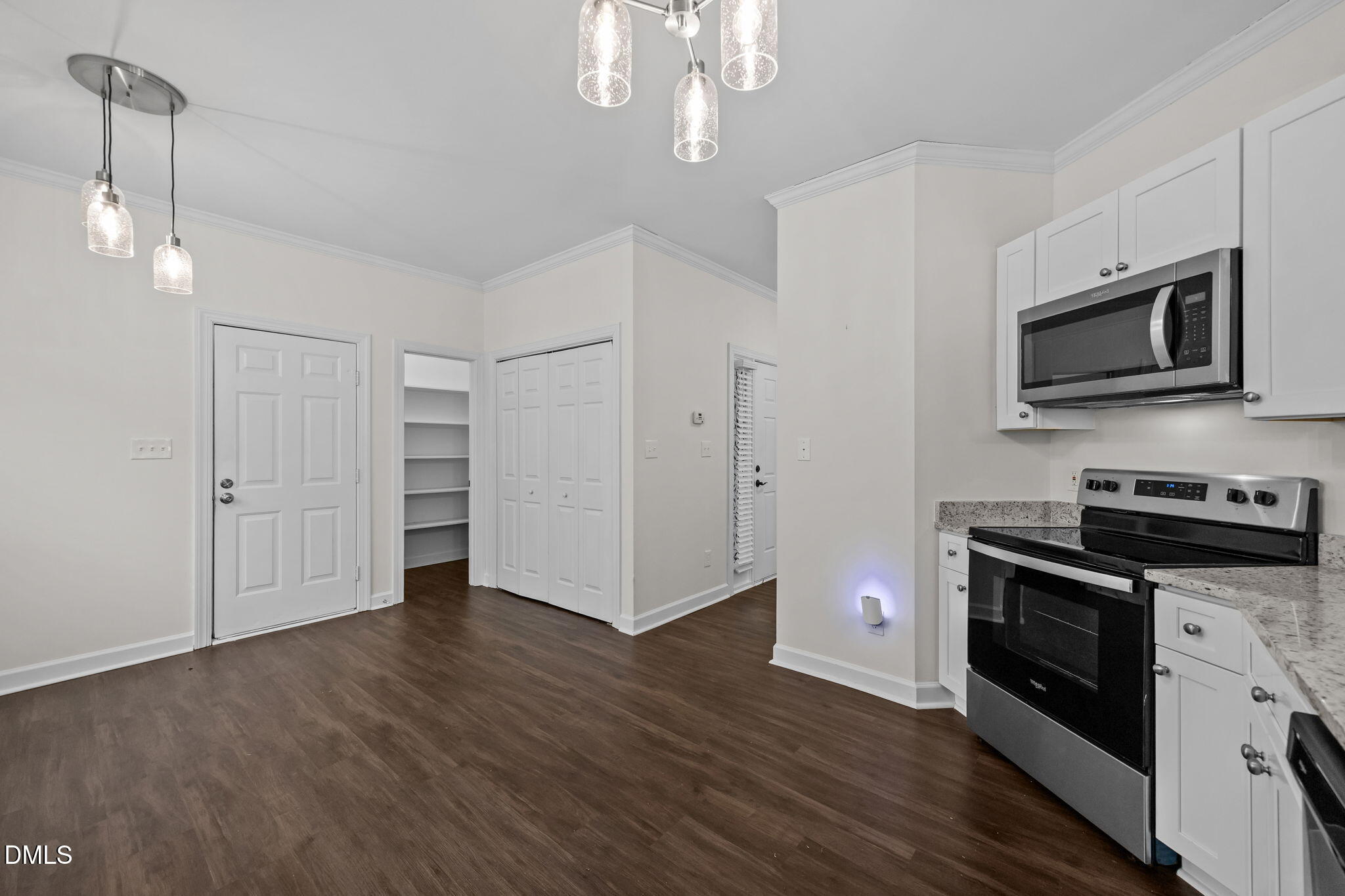 1953 Castle Pines Drive Raleigh, NC 27604 - Photo 12 of 47 a kitchen with stainless steel appliances granite countertop a stove a microwave and a hard wood floors
