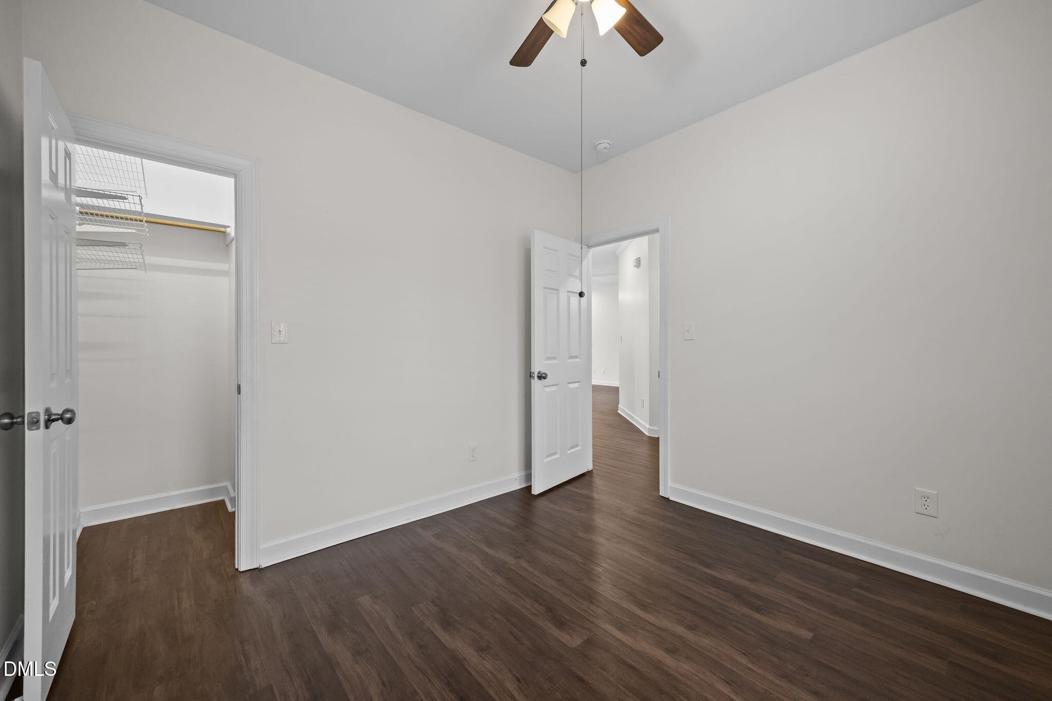 1953 Castle Pines Drive Raleigh, NC 27604 - Photo 16 of 47 an empty room with wooden floor and ceiling fan