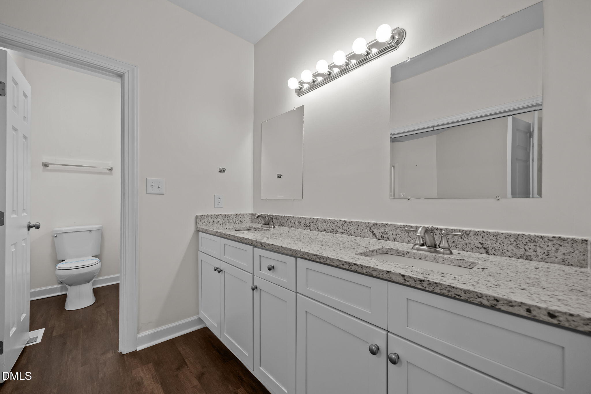 1953 Castle Pines Drive Raleigh, NC 27604 - Photo 21 of 47 a bathroom with a granite countertop sink a toilet and a mirror