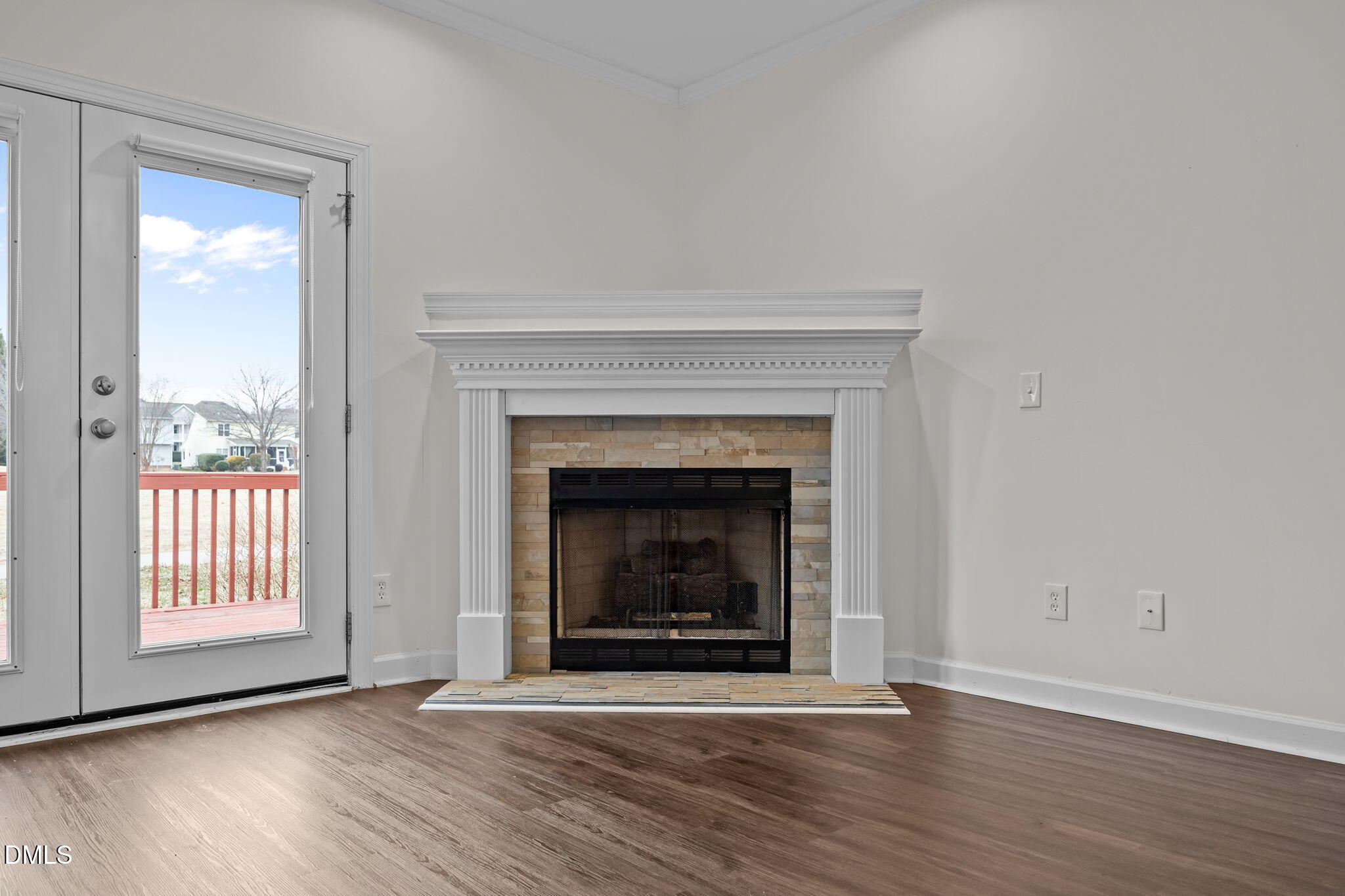 1953 Castle Pines Drive Raleigh, NC 27604 - Photo 27 of 47 an empty room with wooden floor fireplace and windows