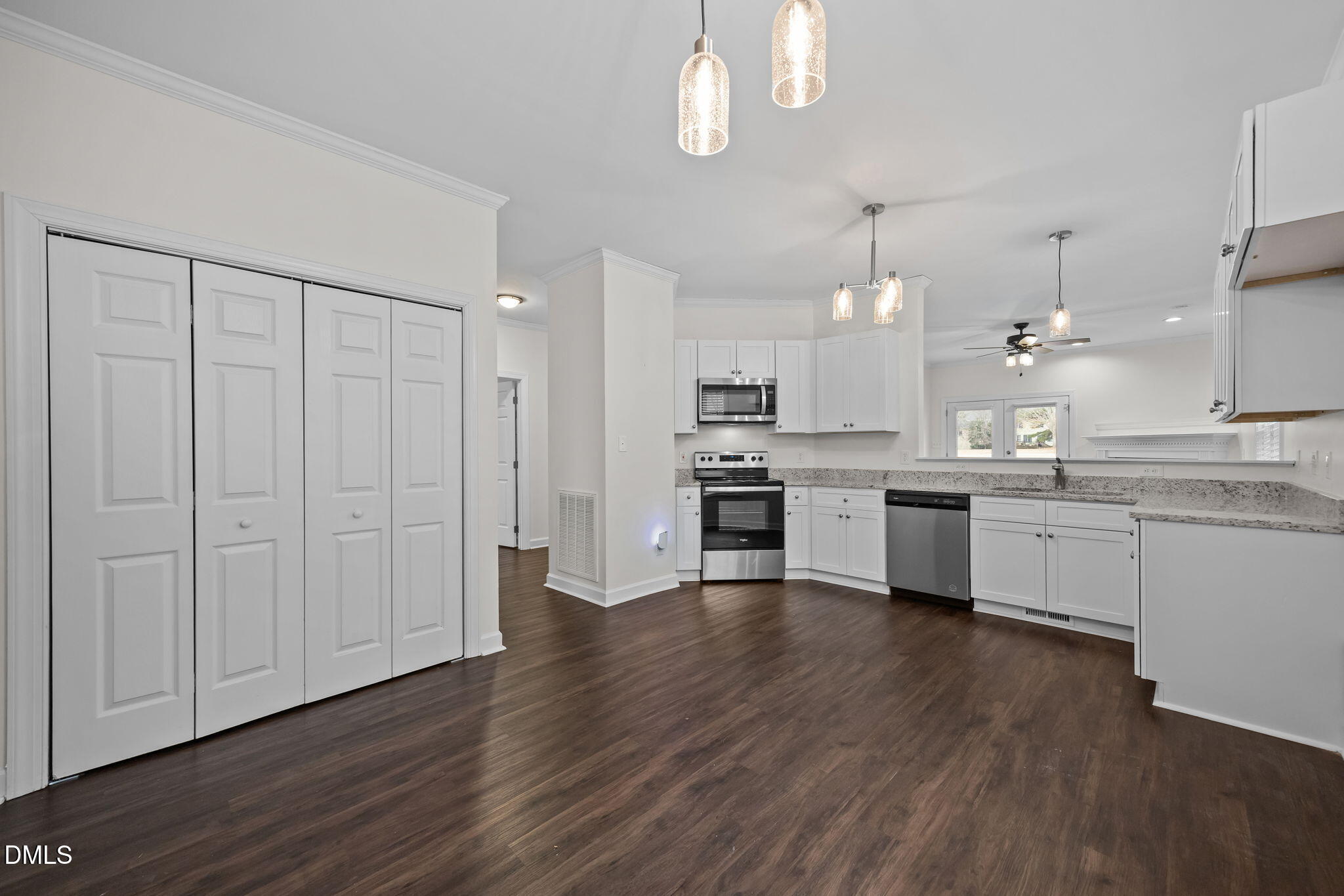 1953 Castle Pines Drive Raleigh, NC 27604 - Photo 7 of 47 a large kitchen with cabinets wooden floor and stainless steel appliances