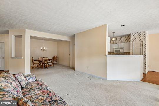 9511 Kingscroft Terrace, Unit 9511F Perry Hall, MD 21128 - Photo 17 of 38 a bed room with a bed and a chair