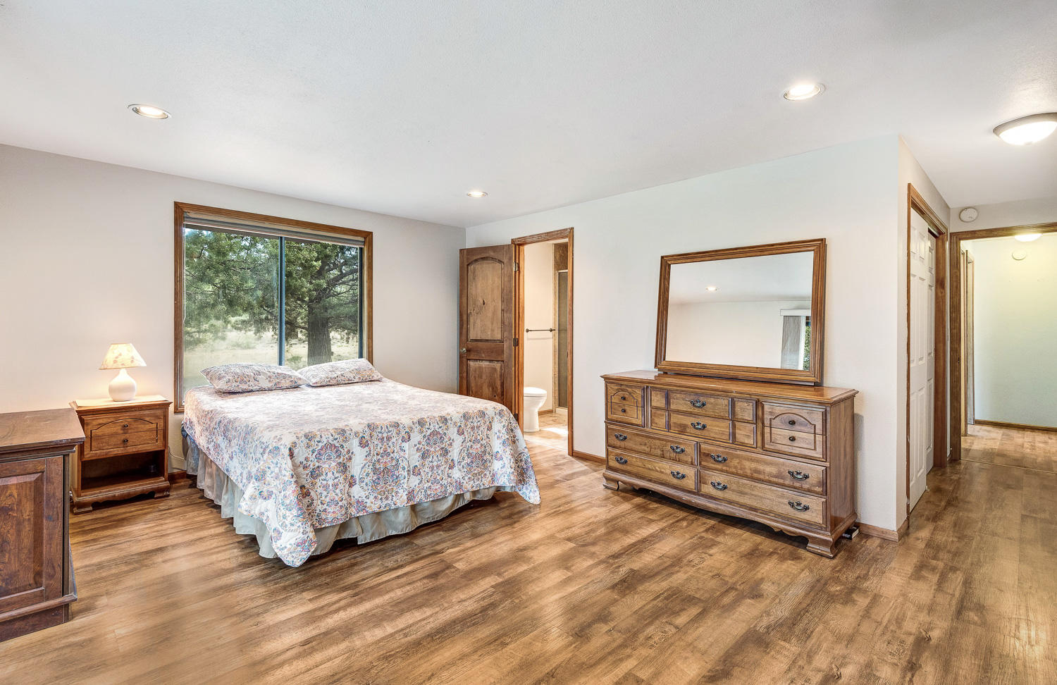 64736 Sylvan Loop Bend, OR 97701 - Photo 19 of 46 a bedroom with a bed and wooden floor