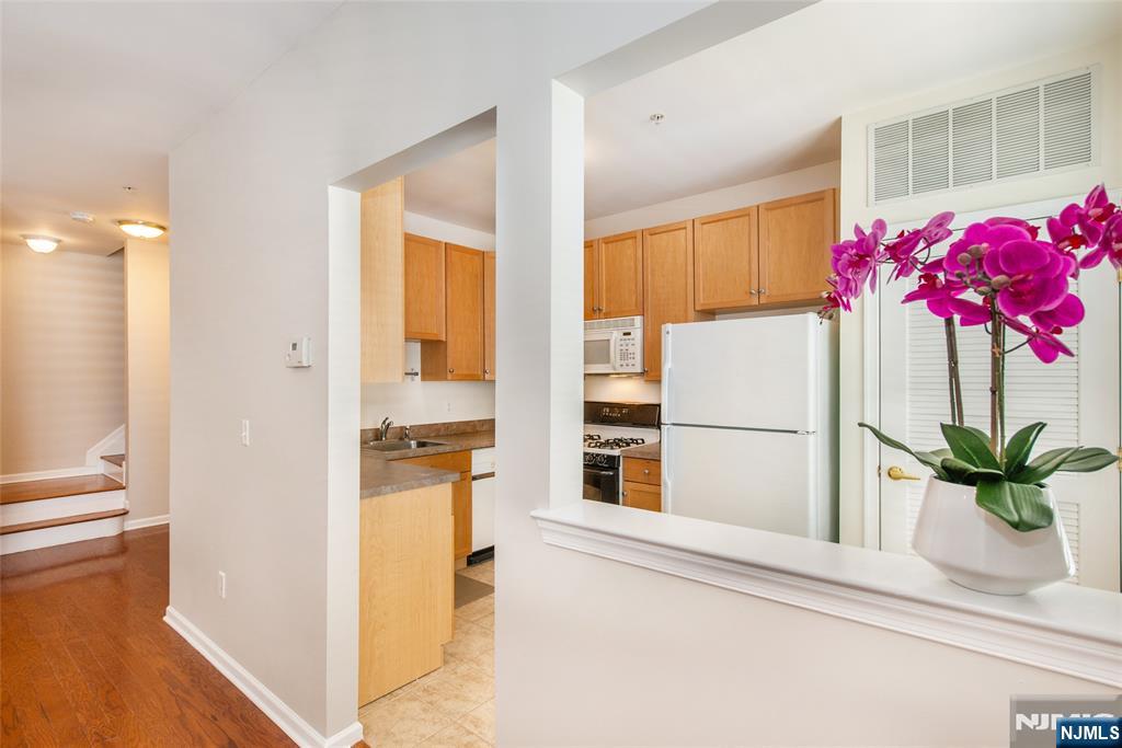 201 Dey Street, Unit 124 Harrison, NJ 07029 - Photo 11 of 26 a kitchen with a refrigerator and a stove