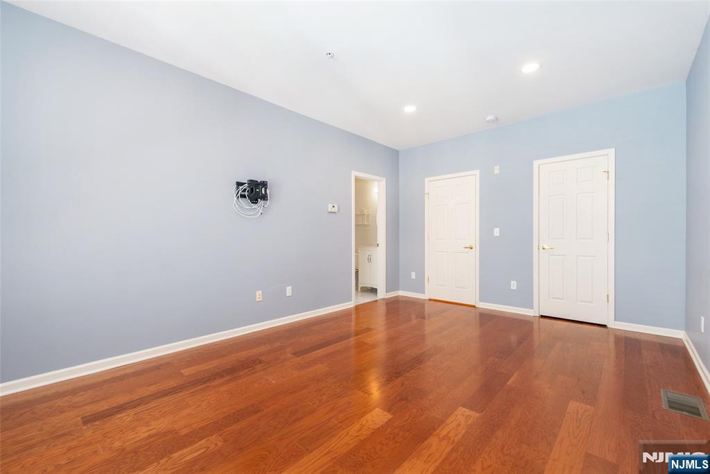 201 Dey Street, Unit 124 Harrison, NJ 07029 - Photo 20 of 26 a view of an empty room with wooden floor