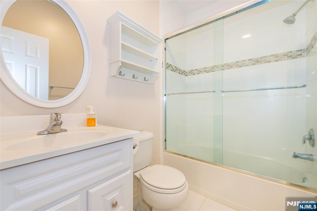 201 Dey Street, Unit 124 Harrison, NJ 07029 - Photo 22 of 26 a bathroom with a sink a toilet and a mirror