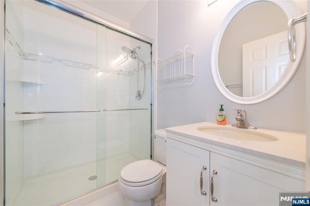 201 Dey Street, Unit 124 Harrison, NJ 07029 - Photo 23 of 26 a bathroom with a sink toilet and shower