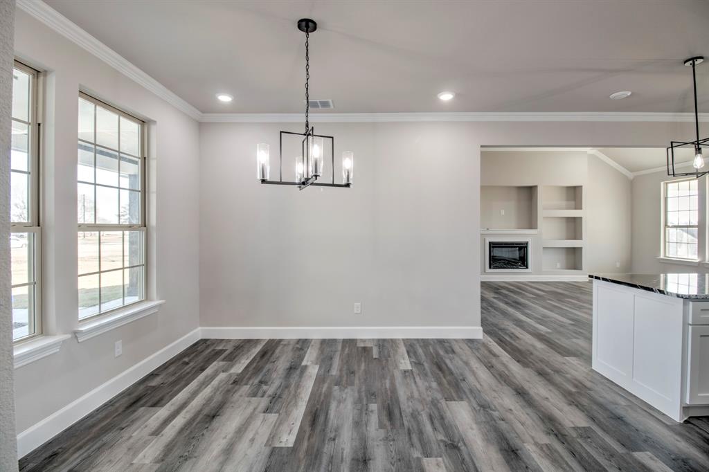 6180 Old Sherman Road Whitesboro, TX 76273 - Photo 11 of 30 a view of empty room with wooden floor and fan