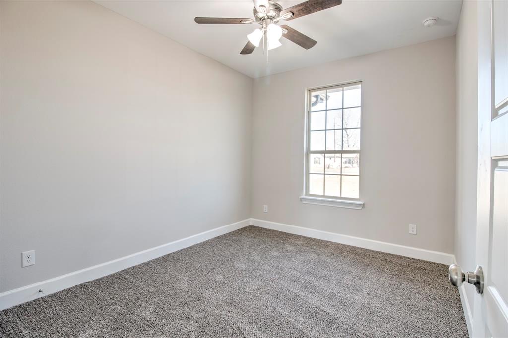 6180 Old Sherman Road Whitesboro, TX 76273 - Photo 18 of 30 an empty room with windows and fan