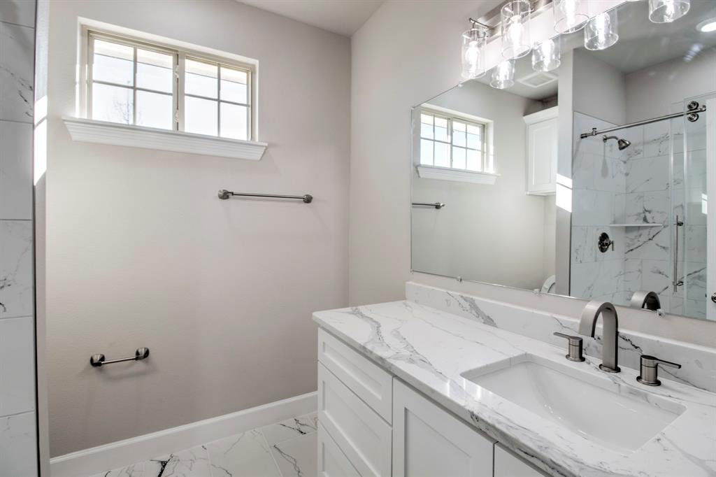 6180 Old Sherman Road Whitesboro, TX 76273 - Photo 21 of 30 a bathroom with a sink and a mirror