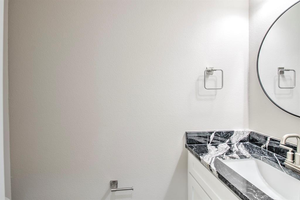 6180 Old Sherman Road Whitesboro, TX 76273 - Photo 23 of 30 a bathroom with a sink and a mirror