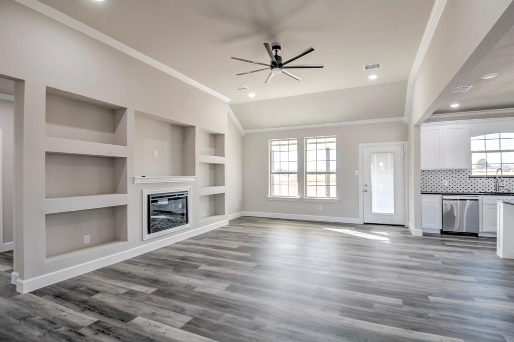 6180 Old Sherman Road Whitesboro, TX 76273 - Photo 5 of 30 a view of an empty room with a kitchen and a window