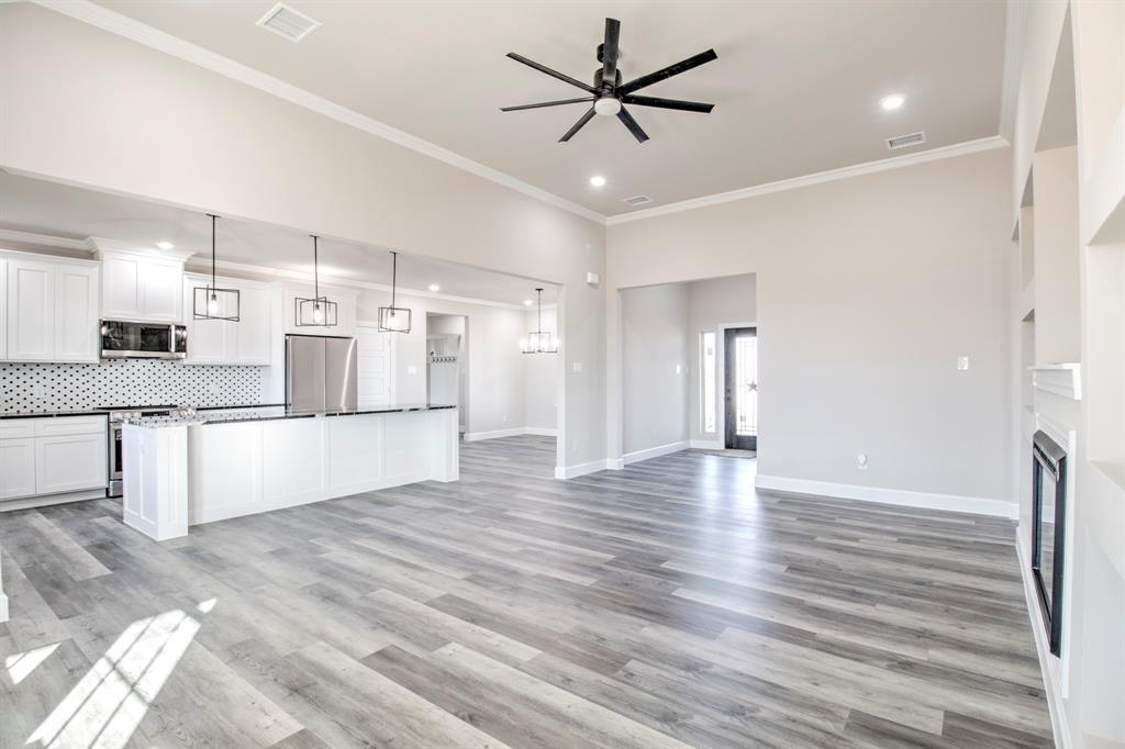 6180 Old Sherman Road Whitesboro, TX 76273 - Photo 7 of 30 a view of a kitchen with a sink and a refrigerator