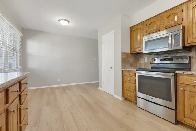 a kitchen with stainless steel appliances a stove microwave and sink