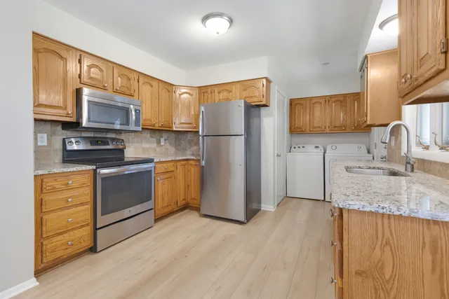 a kitchen with a refrigerator sink and microwave