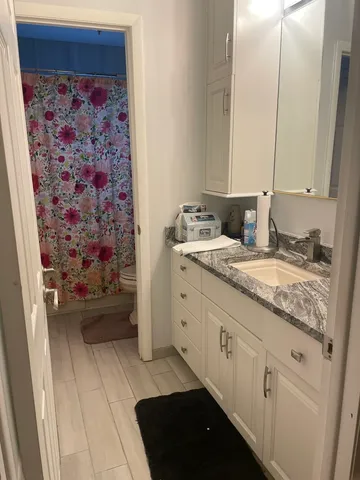 a bathroom with a double vanity sink and a mirror