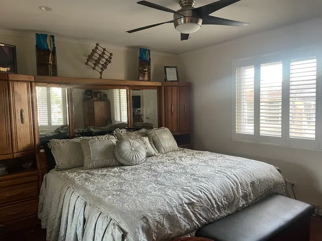 a bedroom with a bed and painting on the wall