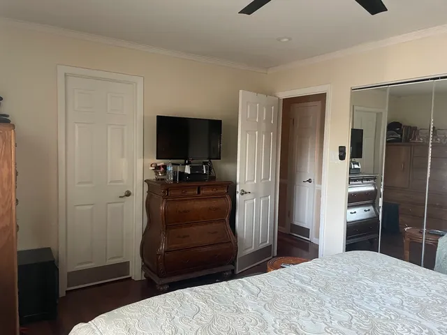 a bedroom with a bed and a flat tv screen in it