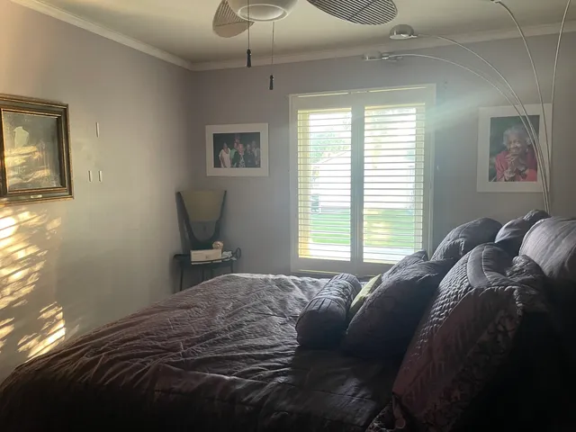 a bedroom with a bed and window