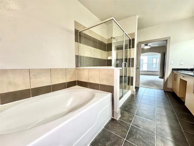 a bathroom with a bathtub and a shower