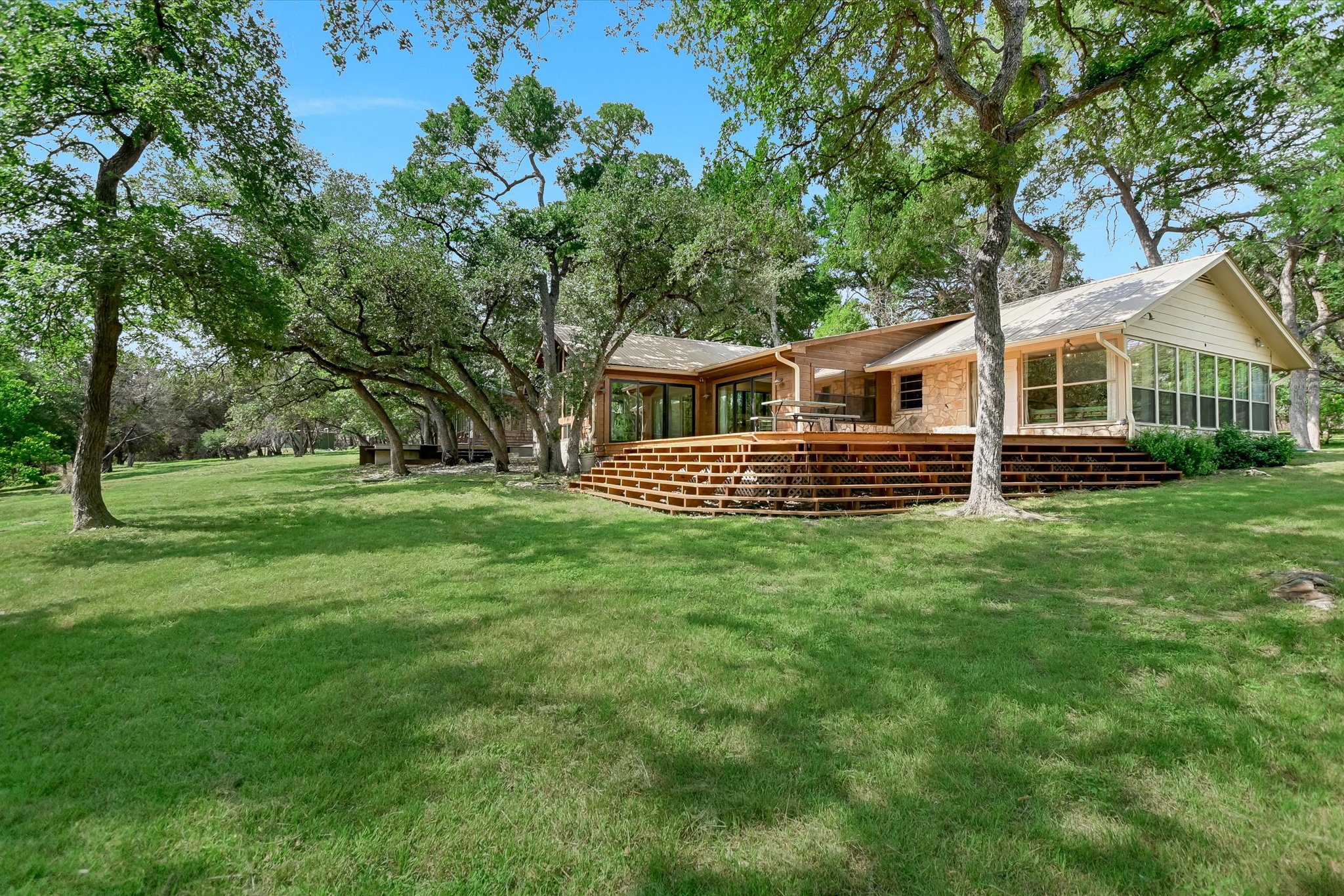 505 Deer Lake Road Wimberley, TX 78676 - Photo 34 of 38 View of yard featuring a sunroom and a wooden deck