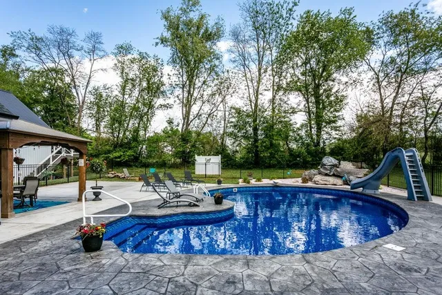 a view of a swimming pool with chairs and tables