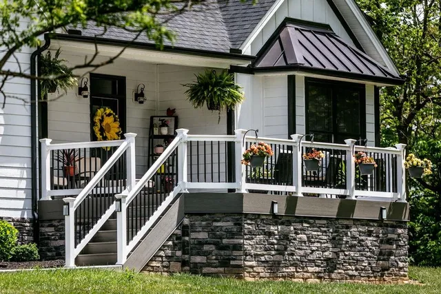 a view of a house with wooden stairs and a small yard