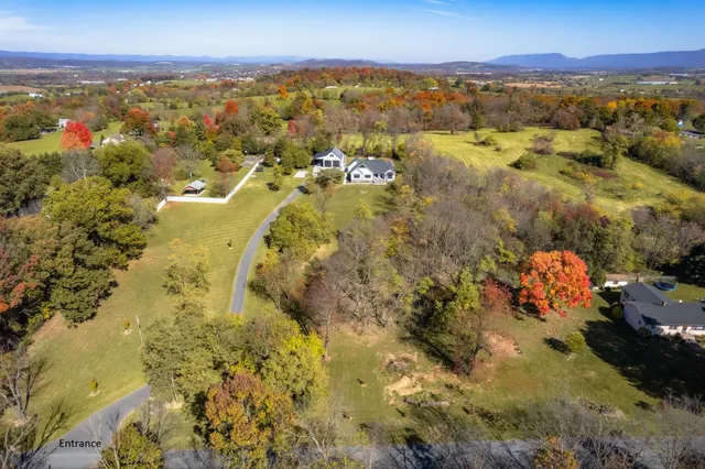 a view of a field with trees in the background
