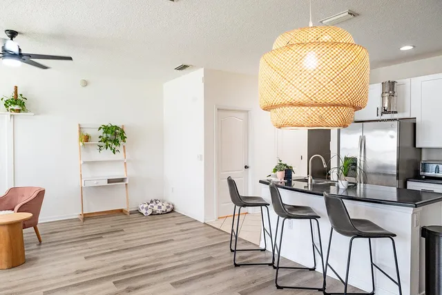 a view of a dining room with furniture and wooden floor