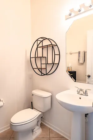 a bathroom with a sink a mirror and a toilet
