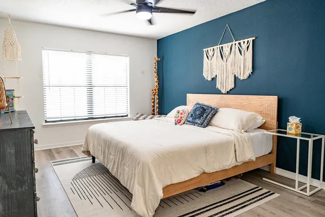 a bedroom with a large bed and a window