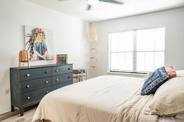 a bedroom with a bed and a window