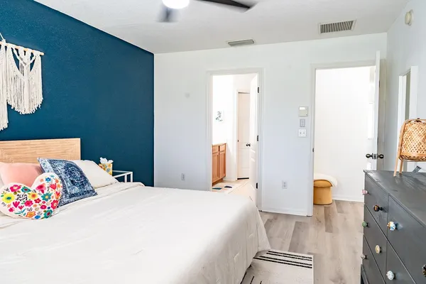 a bedroom with a bed and a dresser