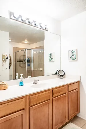 a sink with a view of living room with a sink and large window