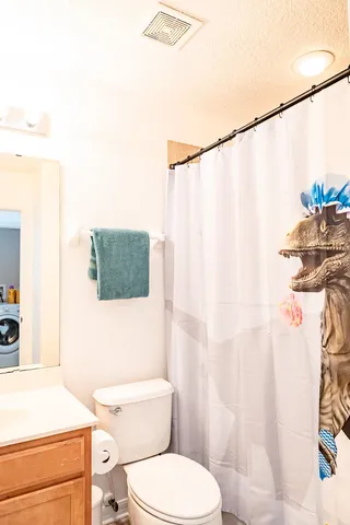 a white toilet sitting next to a bathroom sink
