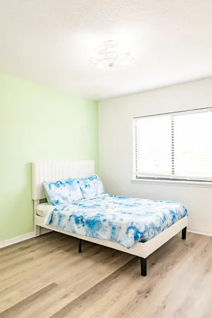 a bedroom with a bed and window