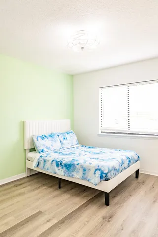 a bedroom with a bed and window