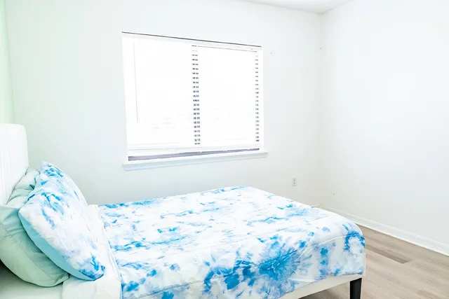 a bedroom with a bed and a window