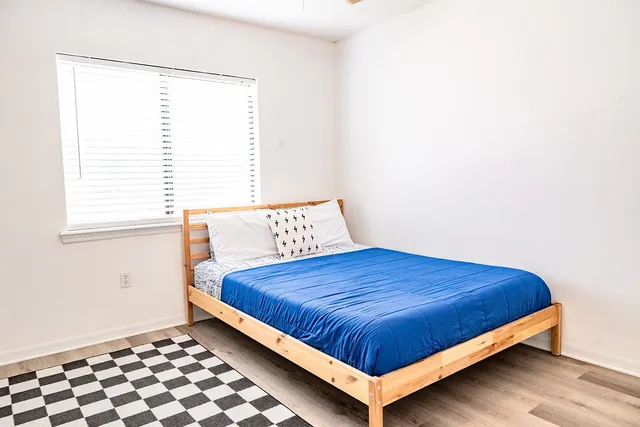 a bedroom with a bed and window