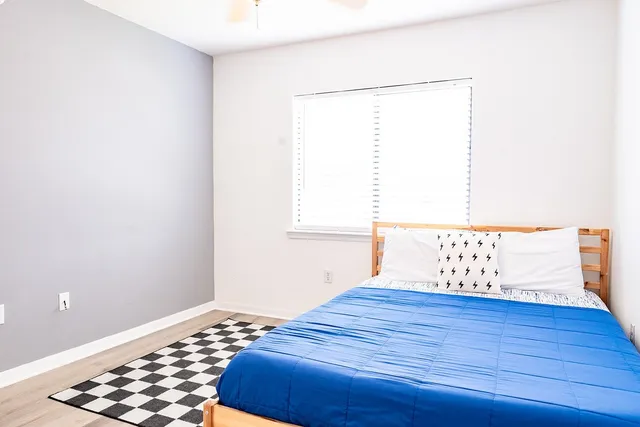 a bedroom with a bed and a window