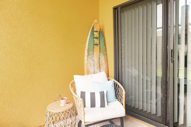 a view of a bedroom with a bed and wooden floor