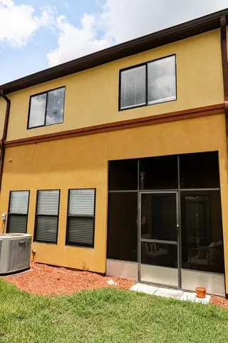 a backyard of a house with wooden fence and a window