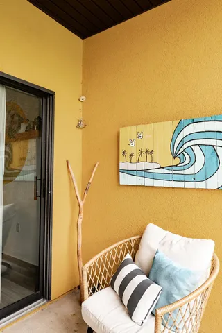 a blue couch sitting next to a bathroom